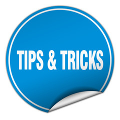 tips & tricks round blue sticker isolated on white