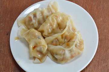 vegetarian steamed Chinese dumpling dressing soy sauce on dish