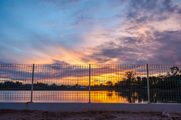 Fototapeta premium Sunrise at the lakeside fence and eliminate freedom.