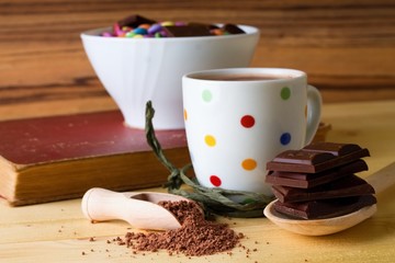 Cocoa in wooden spoon and chocolate