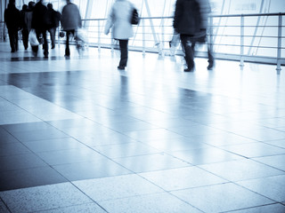 People walking in a shopping center, motion blur