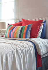 Striped headboard with Colouful pillows and striped pillow on wh