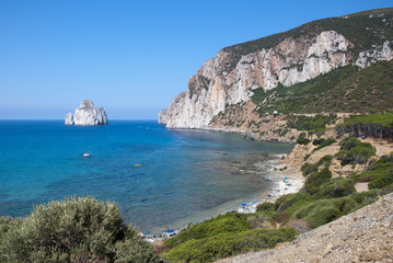 Fototapeta na wymiar Pan di Zucchero rocks in the sea and Masua's sea stack (Nedida), Sardinia