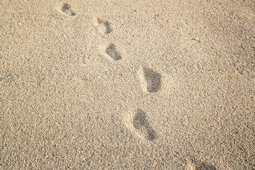 Human footprints on beach sand.