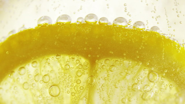 Lime slice in soda water. Macro close-up 4K UHD 2160p footage.
