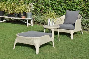 Obraz premium green garden with an outdoor furniture lounge group with rattan
