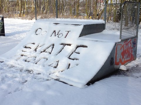 snow covered skateboard ramp, extreme sport