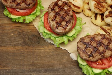 Picnic Table Top With BBQ Grilled Burgers And Vegetables