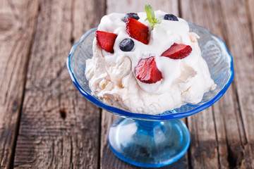Pavlova meringue cake with cream and berry.selective focus