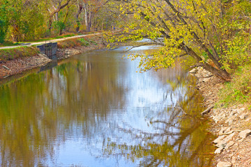 Trees along the Chesapeake and Ohio Canal in autumn foliage. Canal along the north bank of the Potomac River in Washington DC, USA.