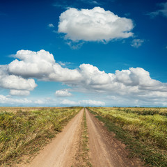 rural road and deep blue sky with clouds