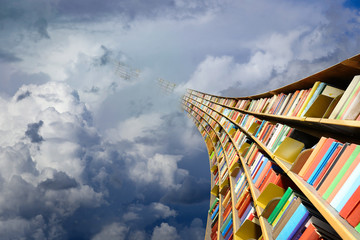 Obraz premium Round flying bookshelf against blue sky