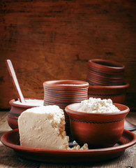 Homemade cottage cheese in a brown pottery bowl in country style