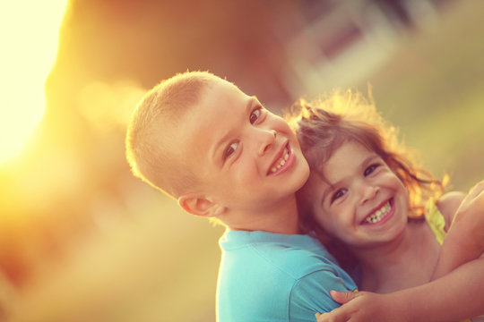 Brother And Sister In Hug With Love And Big Happy Smile. Shalow