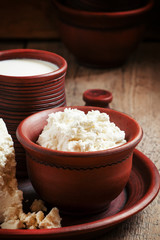 Homemade cottage cheese in a brown pottery bowl in country style