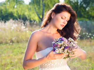 Fototapeta premium outdoor portrait of beautiful woman with flowers