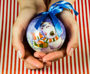 Christmas ball in hands isolated