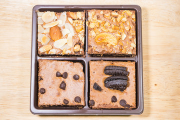 Homemade brownies sliced and  topping on  wooden background