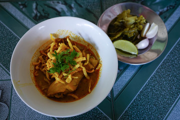 Northern Thai Noodle Curry Soup in bowl serve with lemon , onion