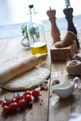 Close-up of different ingredients for pizza on table.