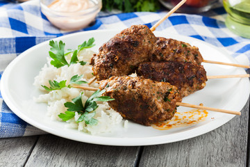 Barbecued kofta with rice on a plate