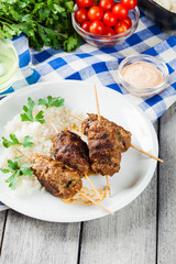 Barbecued kofta with rice on a plate