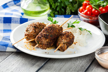 Barbecued kofta with rice on a plate