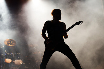 silhouette of a a guitarist on stage