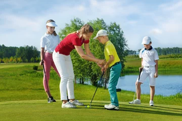 Fototapete Rund Trainer works with children at golf school © Iurii Sokolov