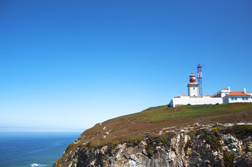 Fototapeta na wymiar Lighthouse close to the sea in a sunny day