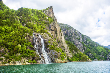 Famous Hengjanefossen waterfall coming down from a steep rock face into Lysefjord, Rogaland, Norway
