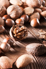 Fototapeta premium Mixed nuts on a wooden background