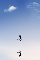 Joyful businesswoman leaps on the clear sky