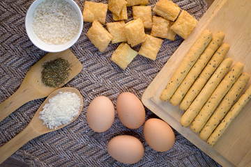 Different fresh bread and ingredients on beige fabric.jpg