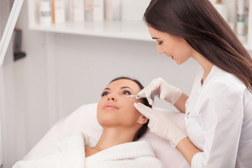 Fototapeta na wymiar Cosmetologist giving cosmetic procedure with syringe