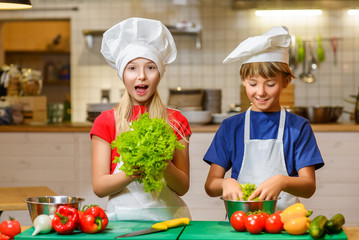Happy smiling Chef boy and girl preparing healthy food at