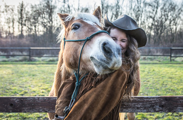 Funny portrait of a girl with an horse