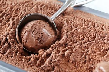 Chocolate ice cream scooped out from container