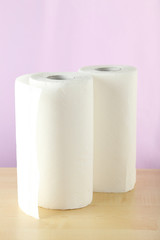 Roll of paper towel on brown wooden background