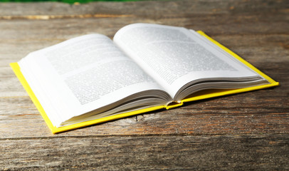 Open book on grey wooden background