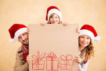 Family holding Christmas poster