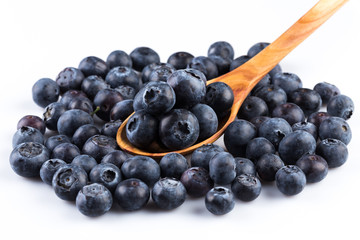 Fresh blueberries in wooden spoon