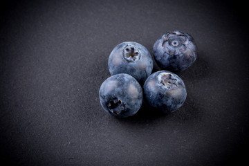 Blueberries on stone plate background