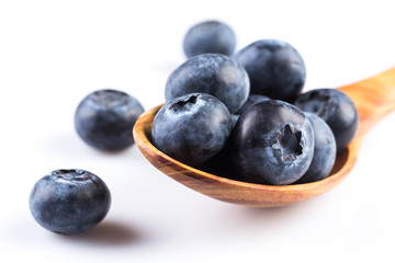 Fresh blueberries in wooden spoon