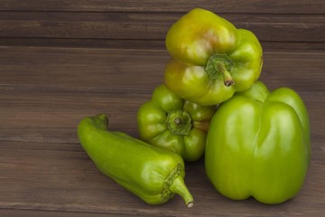 Colorful peppers on rustic wooden table. Freshly harvested peppers on old wooden table. Domestic cultivation of vegetables.  Preparing vegetarian diet. Diet food for athletes.
