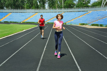 Young people jogging on stadium