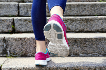 Plakat Young woman jogging at stairs outdoors
