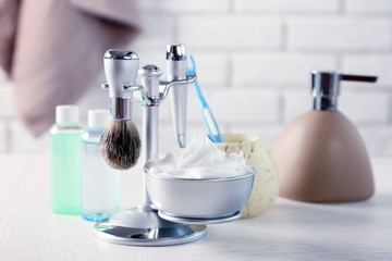 Male luxury shaving kit on shelf, on bricks wall background