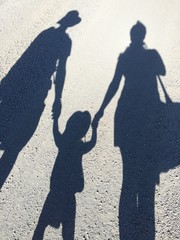 Family silhoutte on a road