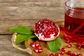 Fresh garnet juice with fruit on table close up